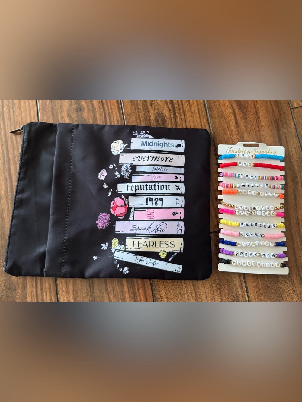 Taylor Swift bracelets and small black bag.
